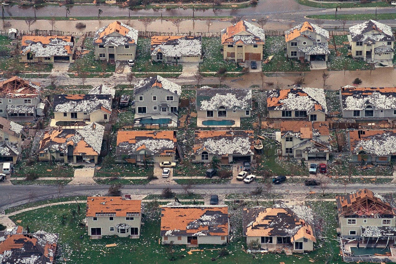 FILE - This Aug. 25, 1992 file photo shows rows of damaged houses between Homestead and Florida City, Fla. Two decades after Andrew devastated the area, Homestead and Florida City have doubled in size into a demographically different community, better prepared to deal with hurricanes. (AP Photo/Mark Foley, File)