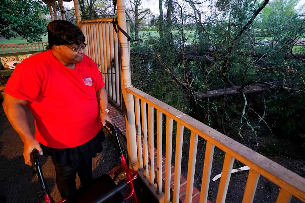 Lydia Macklin examina los daños que sufrió la camioneta de su difunto esposo por el derribo de un árbol durante un brote de mal tiempo en Jackson, Mississippi. "Fui al pasillo y recé durante la tormenta", dijo.