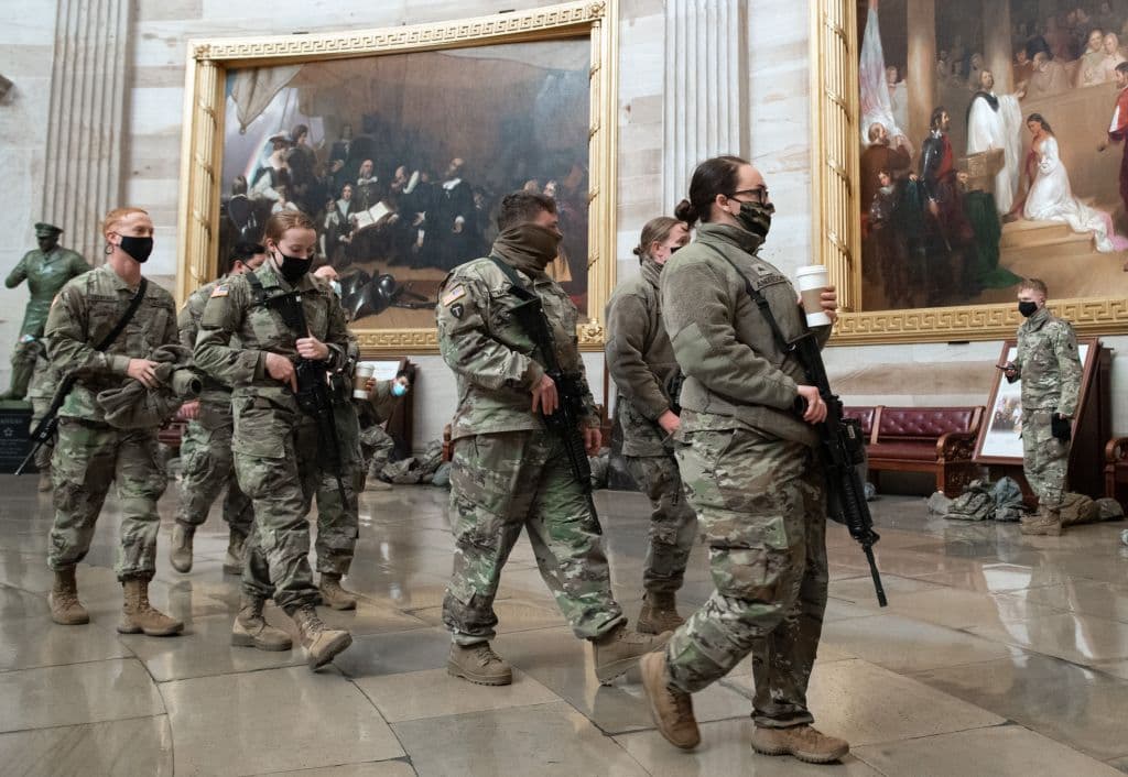 National Guard soldiers carrying assault rifles walk through the Rotunda of the US Capitol in Washington, DC, January 13, 2021. The Pentagon authorized deployment of the Guard for up to 30 days for the inauguration and surrounding protests. Pentagon officials approved requests to have some Guard members armed with either assault rifles or handguns, particularly those Guard members assigned near the U.S. Capitol.