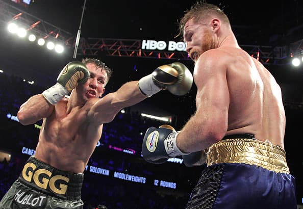 Gennady Golovkin (L) extends a left against Canelo Alvarez (R) during their WBC, WBA and IBF middleweight championship fight at the T-Mobile Arena on September 16, 2017 in Las Vegas, Nevada. Gennady Golovkin retained his three world middleweight titles, fighting to a draw with Mexican star Canelo Alvarez in a showdown for middleweight supremacy that lived up the hype. / AFP PHOTO / John GURZINSKI (Photo credit should read JOHN GURZINSKI/AFP/Getty Images)