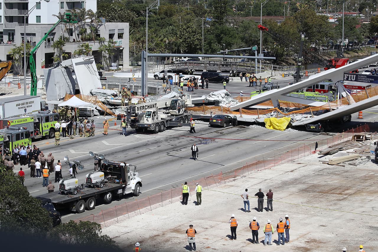 MIAMI, FL - MARCH 15: Miami-Dade Fire Rescue Department personel and other rescue units work at the scene where a pedestrian bridge collapsed a few days after it was built over southwest 8th street allowing people to bypass the busy street to reach Florida International University on March 15, 2018 in Miami, Florida. Reports indicate that there are an unknown number of fatalities as a result of the collapse, which crushed at least five cars. (Photo by Joe Raedle/Getty Images)