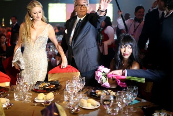 Paris Hilton y Naomi Campbell toman sus asientos antes de la cena.