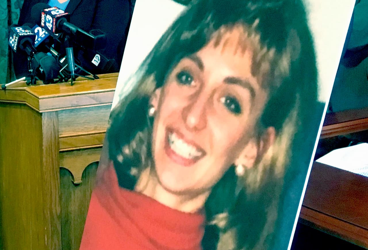 Lancaster County District Attorney Craig Stedman announces charges in a 1992 cold case killing during a news conference at the Lancaster County Courthouse in Lancaster, Pa., Monday, June 25, 2018. A family photo of the victim, Christy Mirack, is seen at right. A popular DJ in Pennsylvania has been charged in the 1992 killing of Mirack, an elementary school teacher who was sexually assaulted, beaten and strangled in her home as she was getting ready for work. (AP Photo/Mark Scolforo)