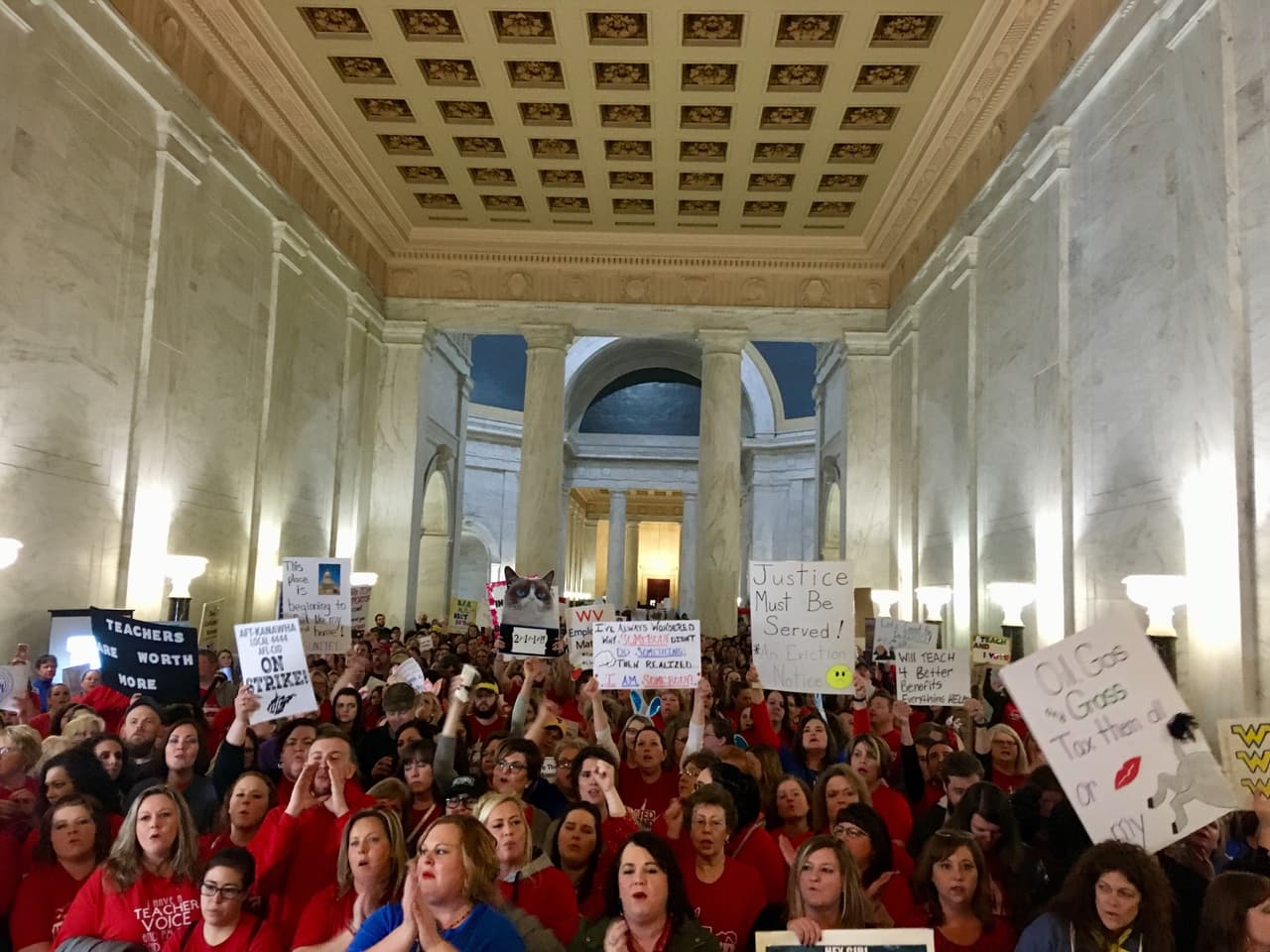 Thousands of teachers rally at the state Capitol in Charleston, W.Va., Thursday, Feb. 22, 2018. Teachers went on strike Thursday over pay and benefits. (AP Photo/John Raby)