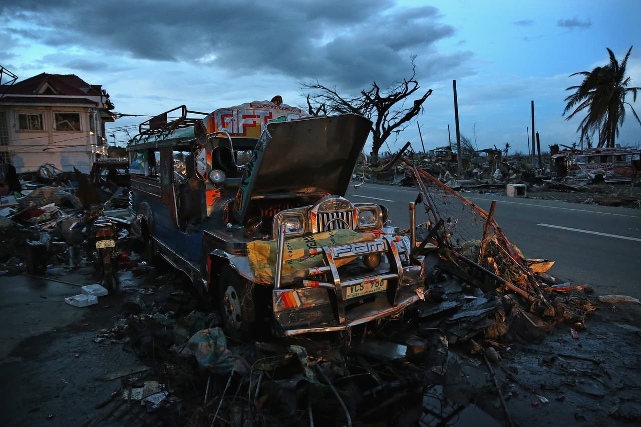 LEYTE, PHILIPPINES - NOVEMBER 21: A Jeepney smashed by Typhoon Haiyan lie amongst the debris in Tacloban on November 21, 2013 in Leyte, Philippines. The Jeepney is a modified form of transport based on the military jeep used by US troops during WWII. It has become the primary mode of transport across the Philippines and part of their national identity. Typhoon Haiyan which ripped through Philippines over a week ago has been described as one of the most powerful typhoons ever to hit land, leaving thousands dead and hundreds of thousands homeless. Countries all over the world have pledged relief aid to help support those affected by the typhoon however damage to the airport and roads have made moving the aid into the most affected areas very difficult. With dead bodies left out in the open air and very limited food, water and shelter, health concerns are growing. (Photo by Dan Kitwood/Getty Images)