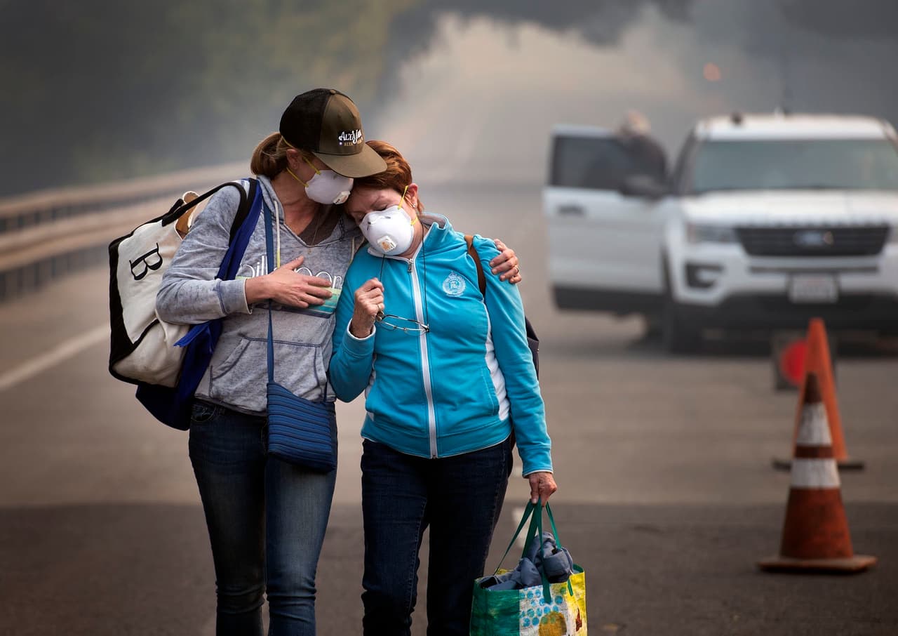 Colby Clark y su madre Bonnie Trexler son escoltadas por la policía a su casa en Napa, de donde esperan recuperar medicinas y artículos personales. 
<br>