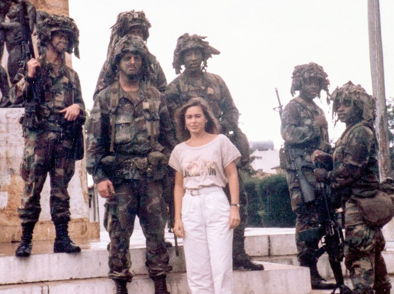 Ines Lozano standing with U.S. troops outside the Spanish embassy during the invasion of Panama, December 1989.