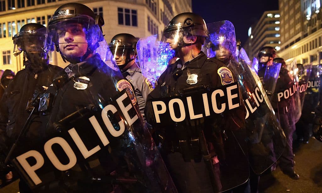 Police push back protesters outside the National Press Club where the Deplorable Ball is being held in Washington, DC on January 19, 2017. / AFP / PAUL J. RICHARDS (Photo credit should read PAUL J. RICHARDS/AFP/Getty Images)