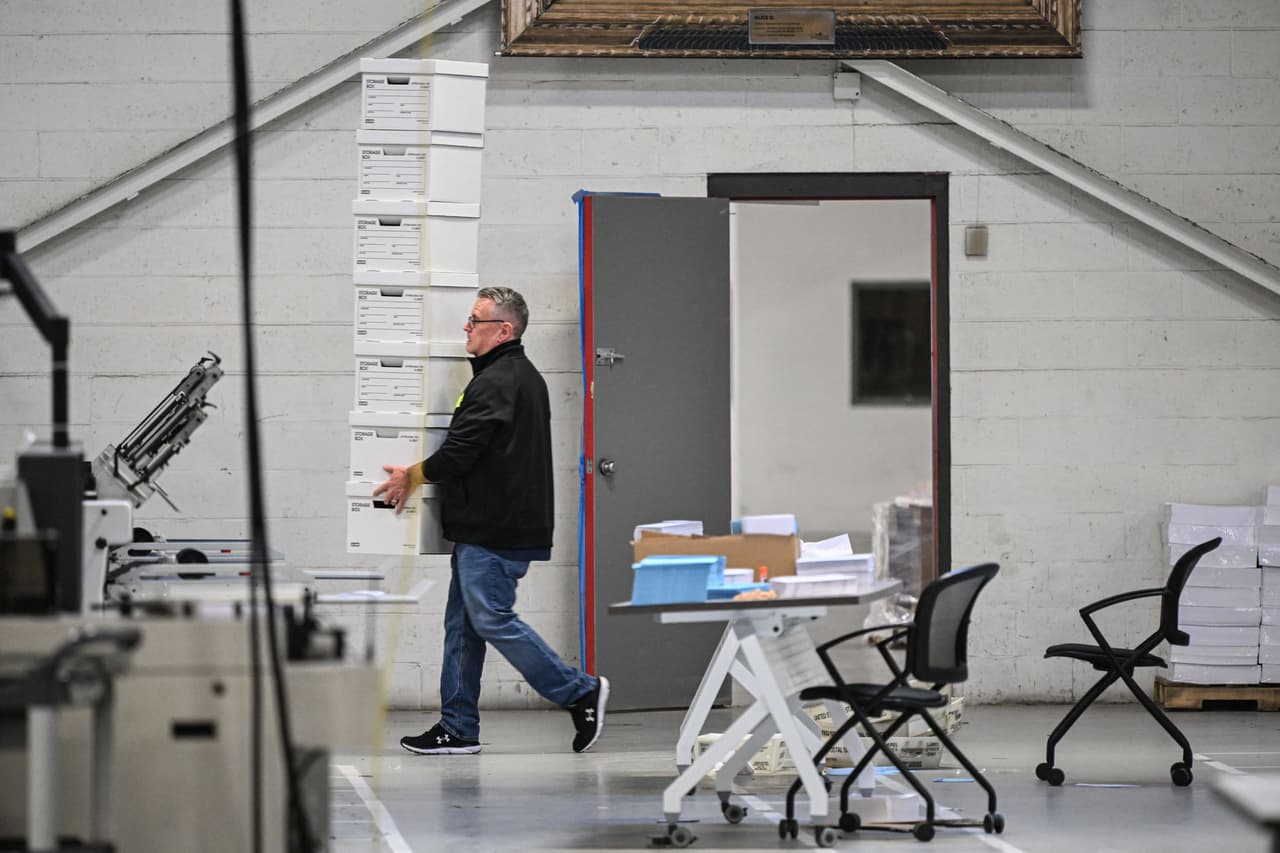 Los trabajadores electorales manipulan las papeletas en un almacén electoral en las afueras de Filadelfia.