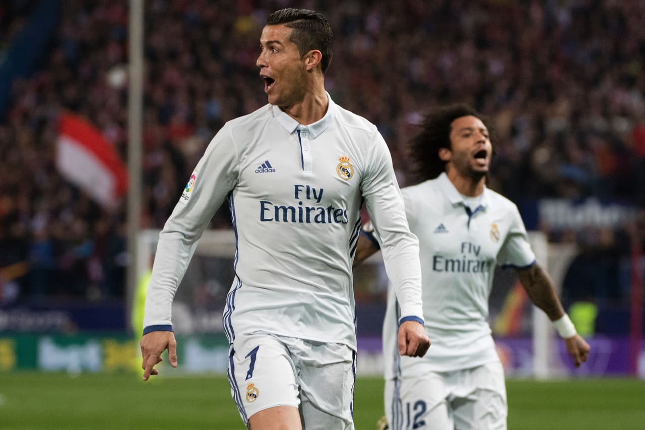 Real Madrid's Portuguese forward Cristiano Ronaldo (R) celebrates after scoring during the Spanish league football match Club Atletico de Madrid vs Real Madrid CF at the Vicente Calderon stadium in Madrid, on November 19, 2016. / AFP / CURTO DE LA TORRE (Photo credit should read CURTO DE LA TORRE/AFP/Getty Images)