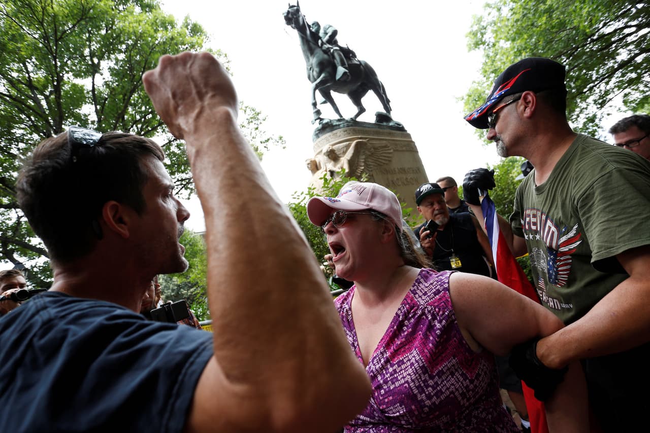 A woman who supports the Confederate monument shouts at a counter-protester.