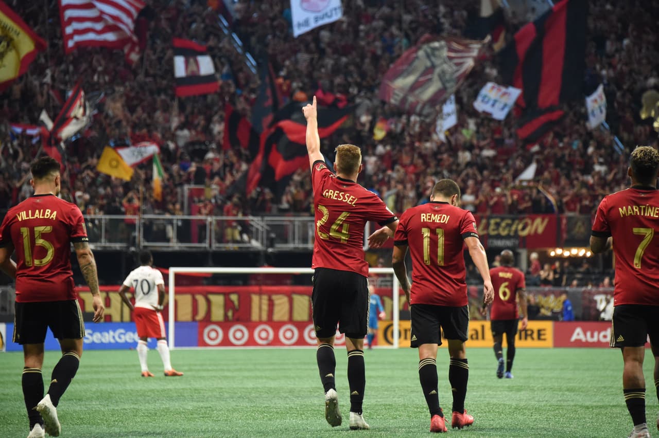 Oct 6, 2018; Atlanta, GA, USA; Atlanta United defender Julian Gressel (24) points to the supporters section after scoring a goal against the New England Revolution during the second half at Mercedes-Benz Stadium. Mandatory Credit: Adam Hagy-USA TODAY Sports