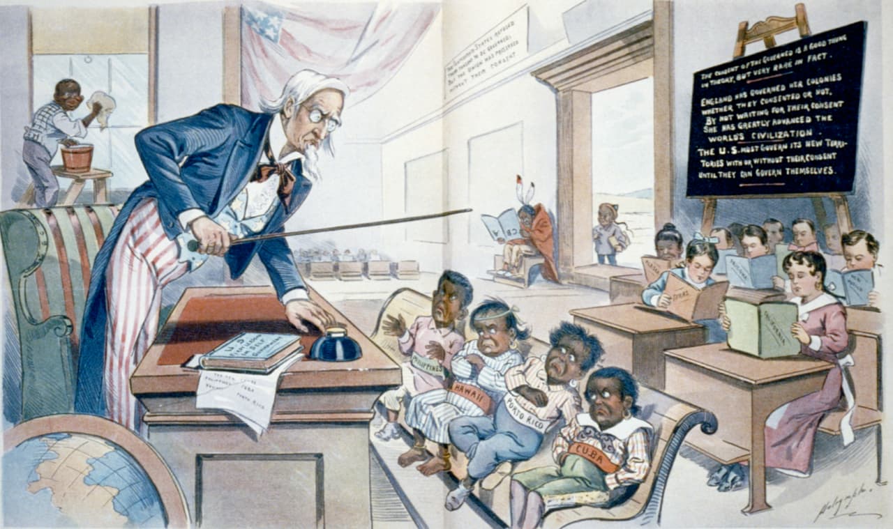 Este dibujo muestra al tío Sam impartiendo clase 
<b>a unos niños malhumorados de piel oscura que representan a Filipinas, Hawaii, Puerto Rico y Cuba.</b> Detrás de ellos están un grupo de estudiantes aplicados: los estados estadounidenses (Texas, California...). En el fondo, se aprecia a un niño chino en el umbral de la escuela, a un indio sujetando un libro al revés y a un negro que limpia la ventana. La viñeta se publicó en 1899 en la revista Puck.