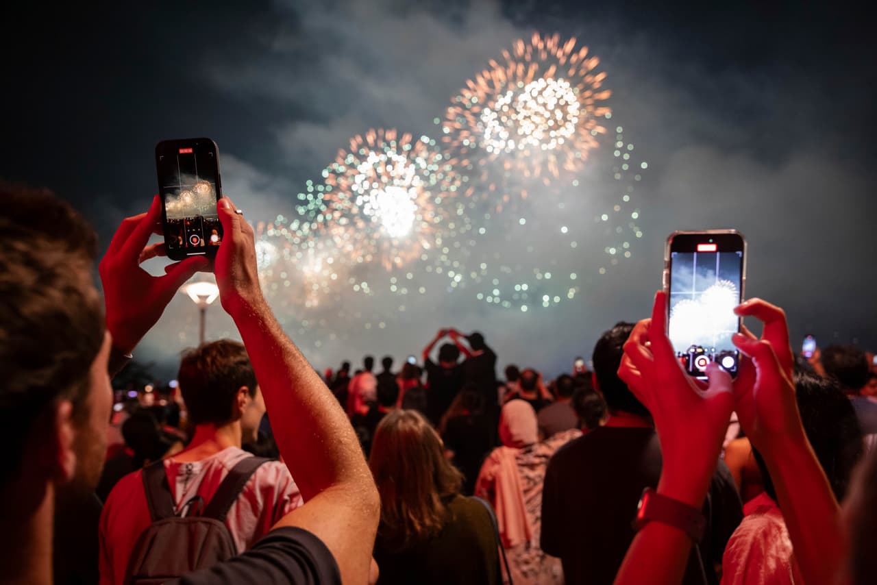 People watch the Macy's Fourth of July fireworks in New York, Tuesday, July 4, 2023. (AP Photo/Yuki Iwamura)