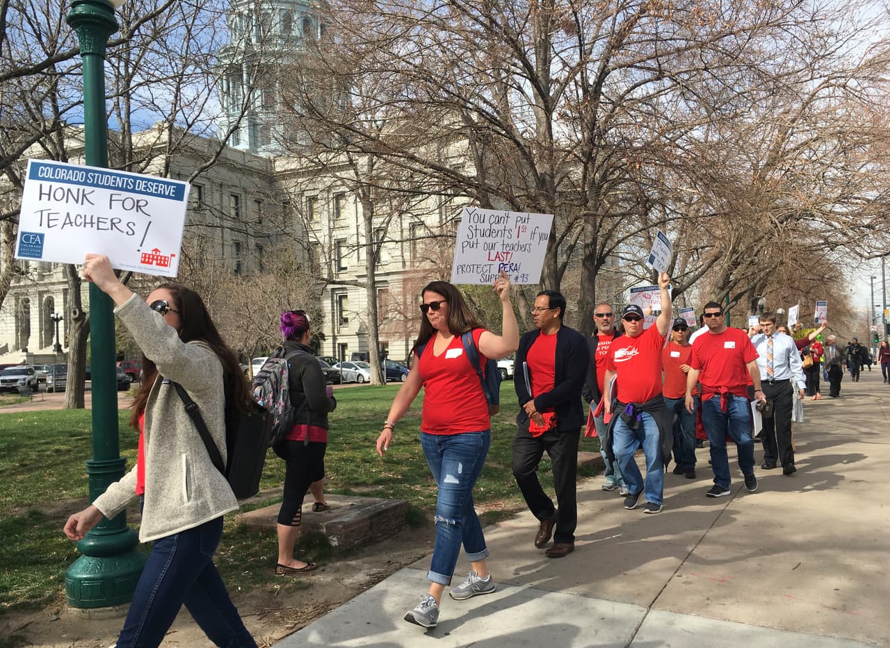 Colorado teachers rally outside the state Capitol to demand more funding for schools and oppose changes to the state's pension system in Denver, Monday, April 16, 2018. They later headed inside to lobby lawmakers in an event organized by the Colorado Education Association, the state's biggest teachers union. (AP Photo/Colleen Slevin)