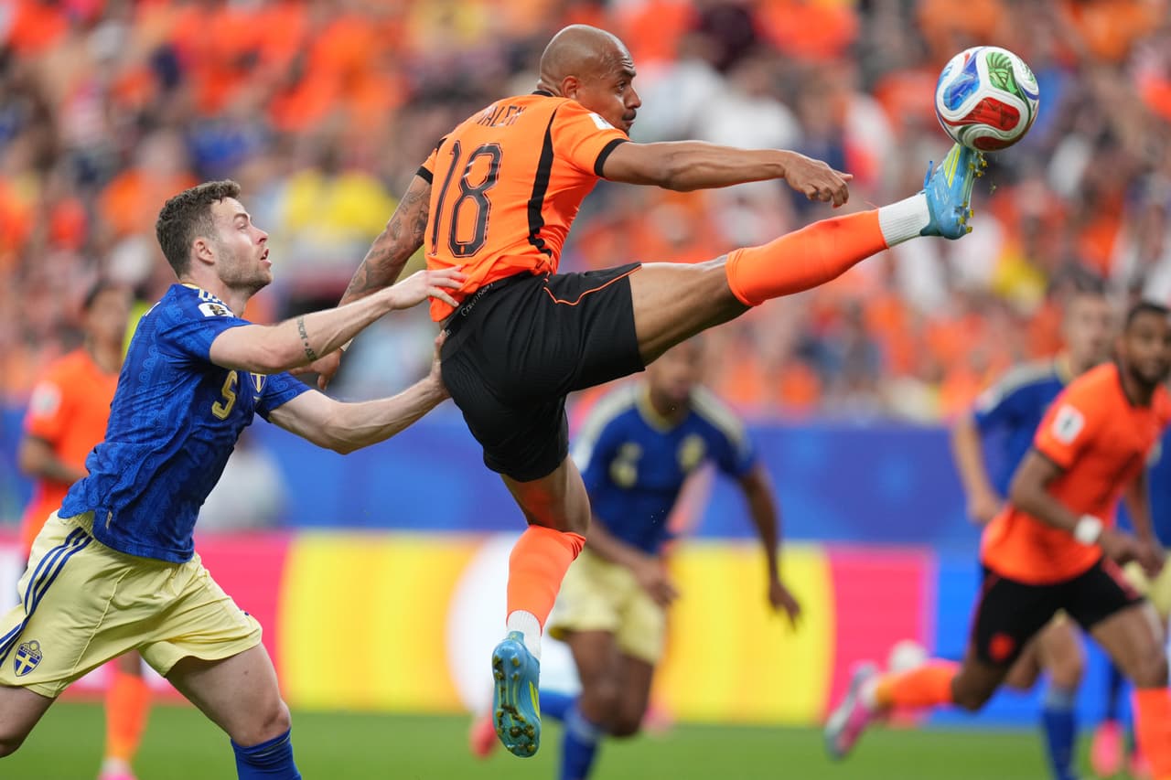Donyell Malen, de los Países Bajos, controla el balón perseguido por Gabriel Gudmundsson, de Suecia.