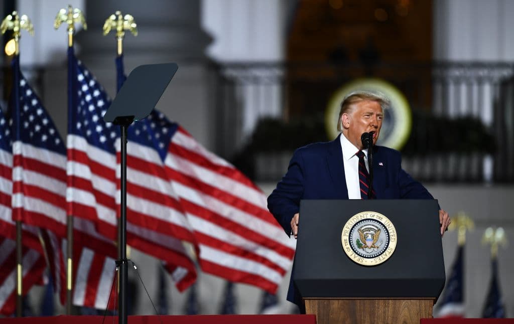 Guests gesture as US President Donald Trump delivers his acceptance speech for the Republican Party nomination for reelection during the final day of the Republican National Convention from the South Lawn of the White House on August 27, 2020 in Washington, DC. (Photo by Brendan Smialowski / AFP) (Photo by BRENDAN SMIALOWSKI/AFP via Getty Images)