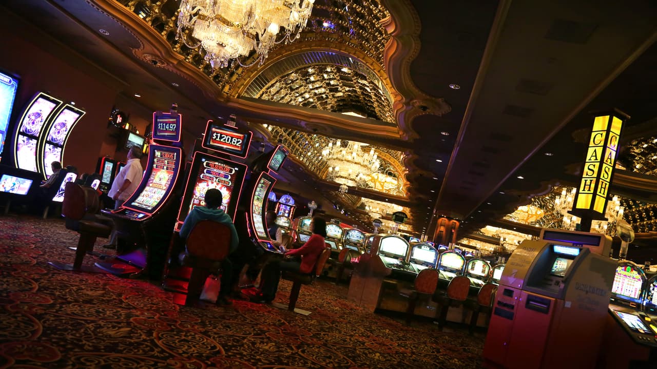Clientes del casino juegan en las maquinas de juego tragamonedas hasta altas horas de la noche en el Trump Taj Mahal en Atlantic City. Carl Icahn, su nuevo dueño, había prometido $100 millones para su recuperación después de comprarlo y sacarlo de la bancarrota, pero amenazó con no invertirlos si se aprobaba la apertura de nuevos casinos en el norte de Nueva Jersey.