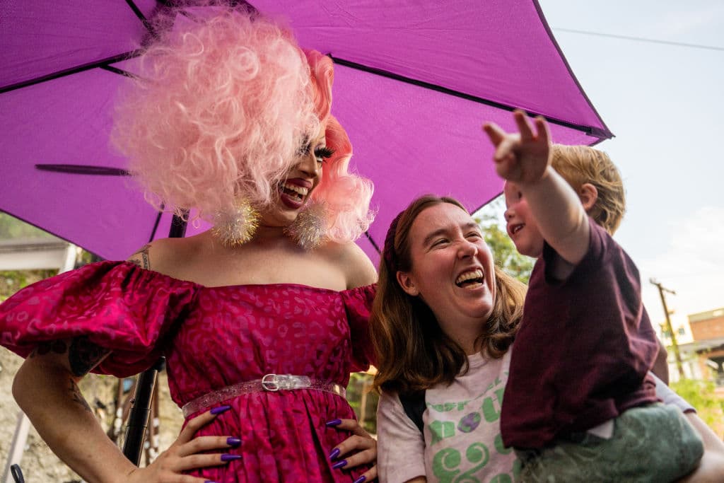 Drag Queen Brigitte Bandit laughs with supporters during a story time reading at the Cheer Up Charlies dive bar on March 11, 2023 in Austin, Texas. Texas Republicans have proposed legislation that would deem any affiliation with drag shows as sexually oriented businesses, including any venue that allows performers to wear clothes or makeup that portray a gender identity that differs from the performer’s gender assigned at birth.