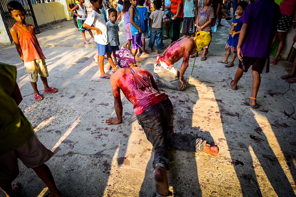 Filipinos participan en una sangrienta celebración de Viernes Santo donde se dan latigazos en sus espaldas y cargan la cruz por largos pasares para darle gracias a Dios.