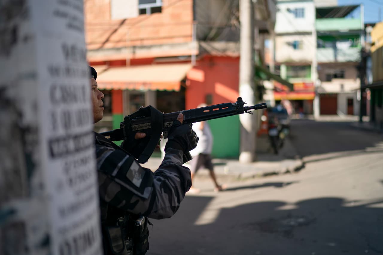 ARCHIVO - En esta foto de archivo del 31 de julio de 2019, un oficial de policía apunta su arma durante una operación en el complejo de favelas de Mare en Río de Janeiro, Brasil. (AP Foto/Leo Correa, Archivo)