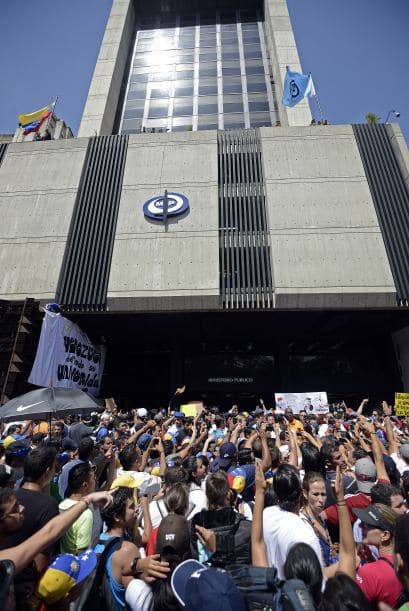 Miles de manifestantes desarmados protestan frente al edificio de la Fiscalía General en Caracas, por la detención arbitraria de dos jóvenes. Los estudiantes llevaron a cabo una manifestación pacífica contra el régimen del mandatario Nicolás Maduro el 12 de febrero de 2014. Motorizados uniformados y con sus caras cubiertas, dispararon contra los manifestantes, matando a dos estudiantes y a un oficial.