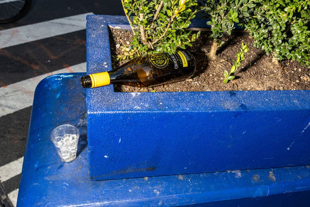 En otra zona, abandonada quedó una botella de Chardonnay casi vacía junto a un vaso con hielo, en Manhattan, Nueva York.