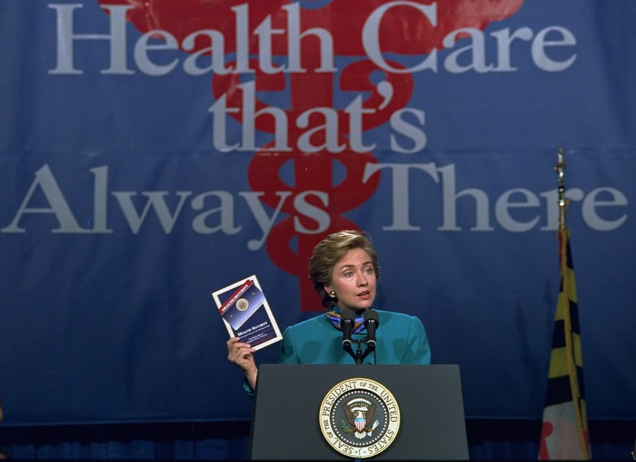 "Servicios de salud que siempre están allí". La entonces primera dama, Hillary Rodham Clinton, sostiene una copia de su plan de salud el 28 de octubre de 1993.