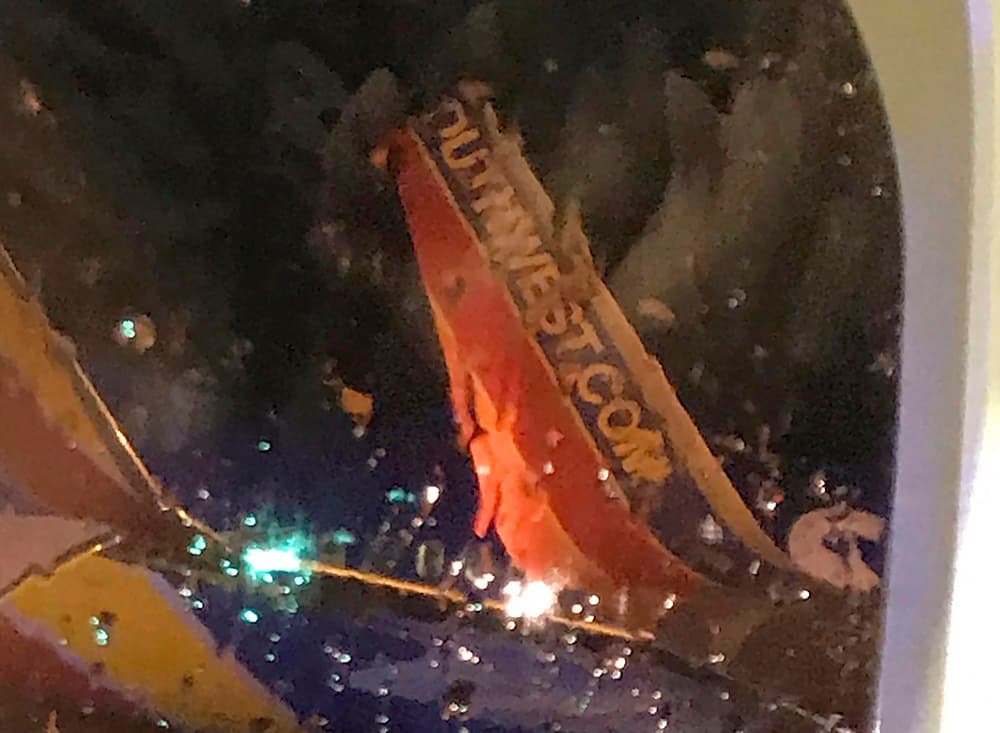 This photo taken onboard by a passenger on a Southwest Airlines flight to Atlanta appears to show the top fin of another Southwest Airlines plane clipped off after the two planes collided, Saturday, July 20, 2019, on the tarmac of Nashville International Airport, in Nashville, Tenn. The airline says both planes returned to the gate "under their own power" and were taken out of service for evaluation. The Southwest flights will continue to the scheduled destinations using news planes. (Eric Borden via AP)