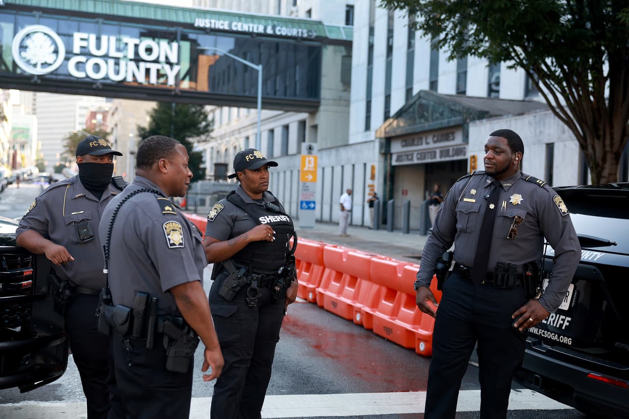 ATLANTA, GEORGIA - AUGUST 07: Fulton County Sheriff officers block off a street in front of the Fulton County Courthouse on August 07, 2023 in Atlanta, Georgia. The heightened security is in place as Fulton County District Attorney Fani Willis is expected to make an announcement soon about a possible grand jury indictment in her investigation into former President Donald Trump and his Republican allies alleged attempt to overturn the 2020 election in the state. (Photo by Joe Raedle/Getty Images)
