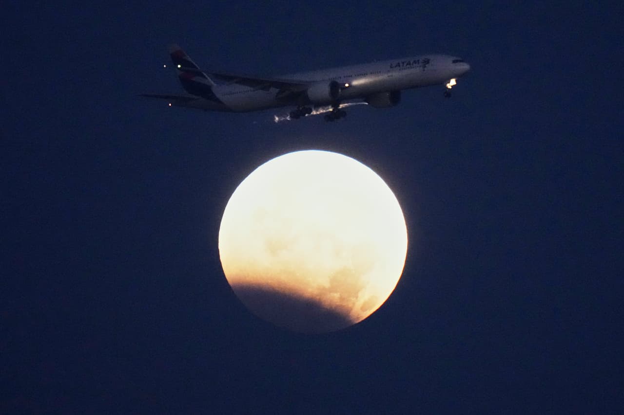 Un Boeing 777 de LATAM Airlines se dispone a aterrizar en Lisboa durante un eclipse lunar parcial, el 28 de agosto de 2026.