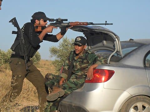 The Dagunov is known for its durability and has been used by snipers in conflicts around the world. In this photo, a Free Syrian Army fighter practices with a Dragunov during training exercises outside Homs, June 2012. Photo by Reuters.