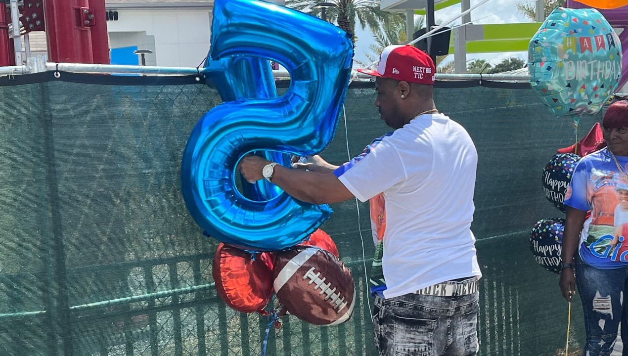 Yarnell Sampson coloca globos en la atracción Freefall de ICON Park donde murió su hijo Tyre a los 14 años de edad en marzo pasado.