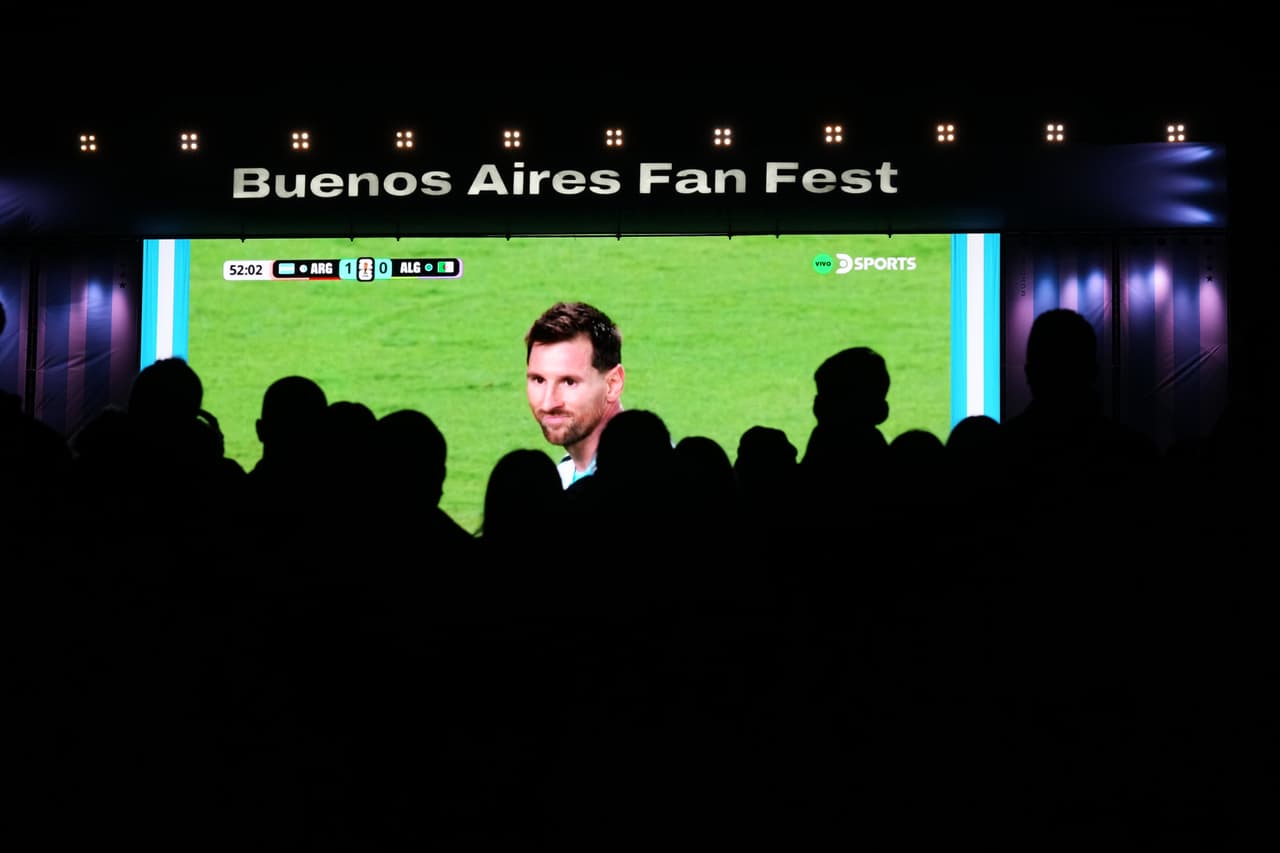 Aficionados observan a Lionel Messi de Argentina en una pantalla gigante durante el partido entre la selección argentina y la de Argelia por la Copa de futbol, el 16 de junio de 2026, en Buenos Aires.