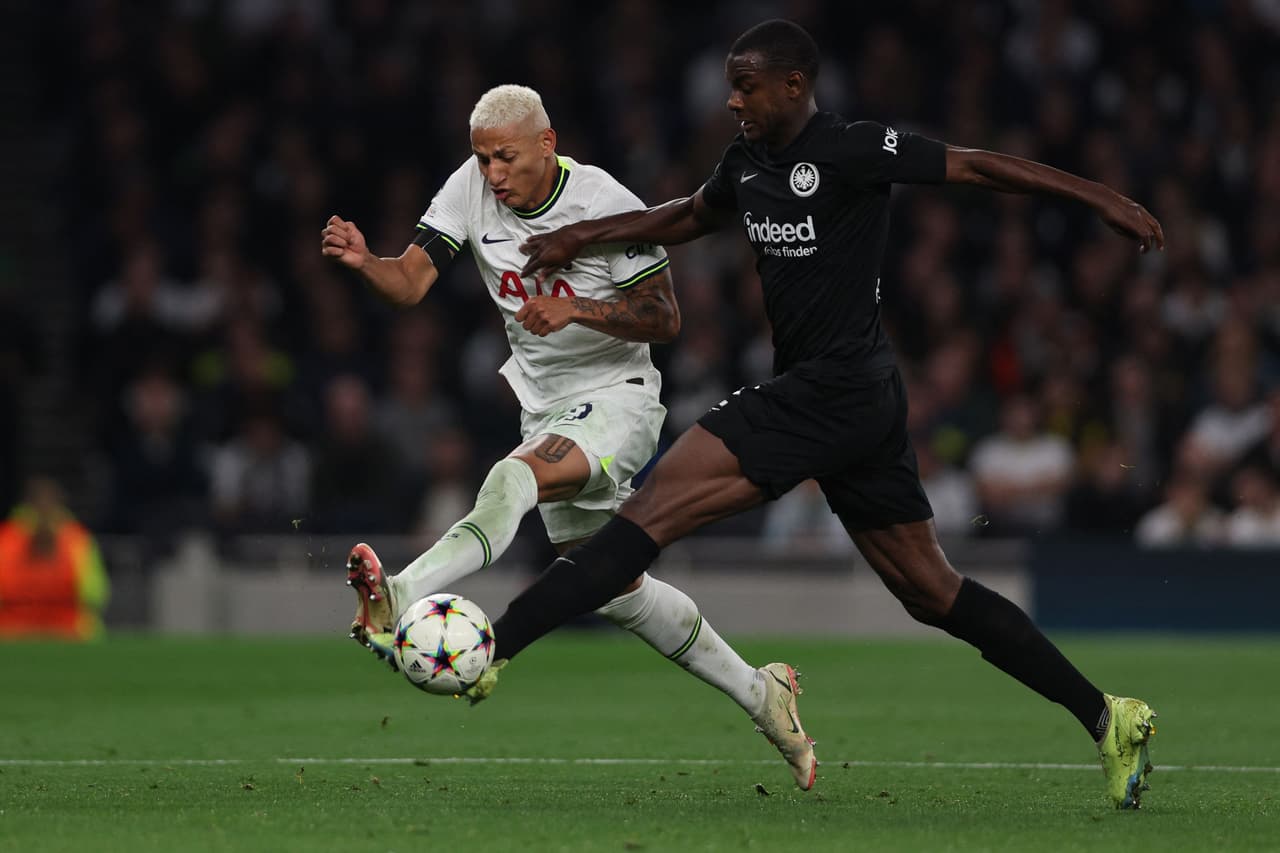 Tottenham Hotspur's Brazilian striker Richarlison (L) fights for the ball with Frankfurt's French defender Evan N'Dicka during the UEFA Champions League Group D football match between Tottenham Hotspur and Eintracht Frankfurt at the Tottenham Hotspur Stadium, in London, on October 12, 2022. (Photo by Adrian DENNIS / AFP) (Photo by ADRIAN DENNIS/AFP via Getty Images)