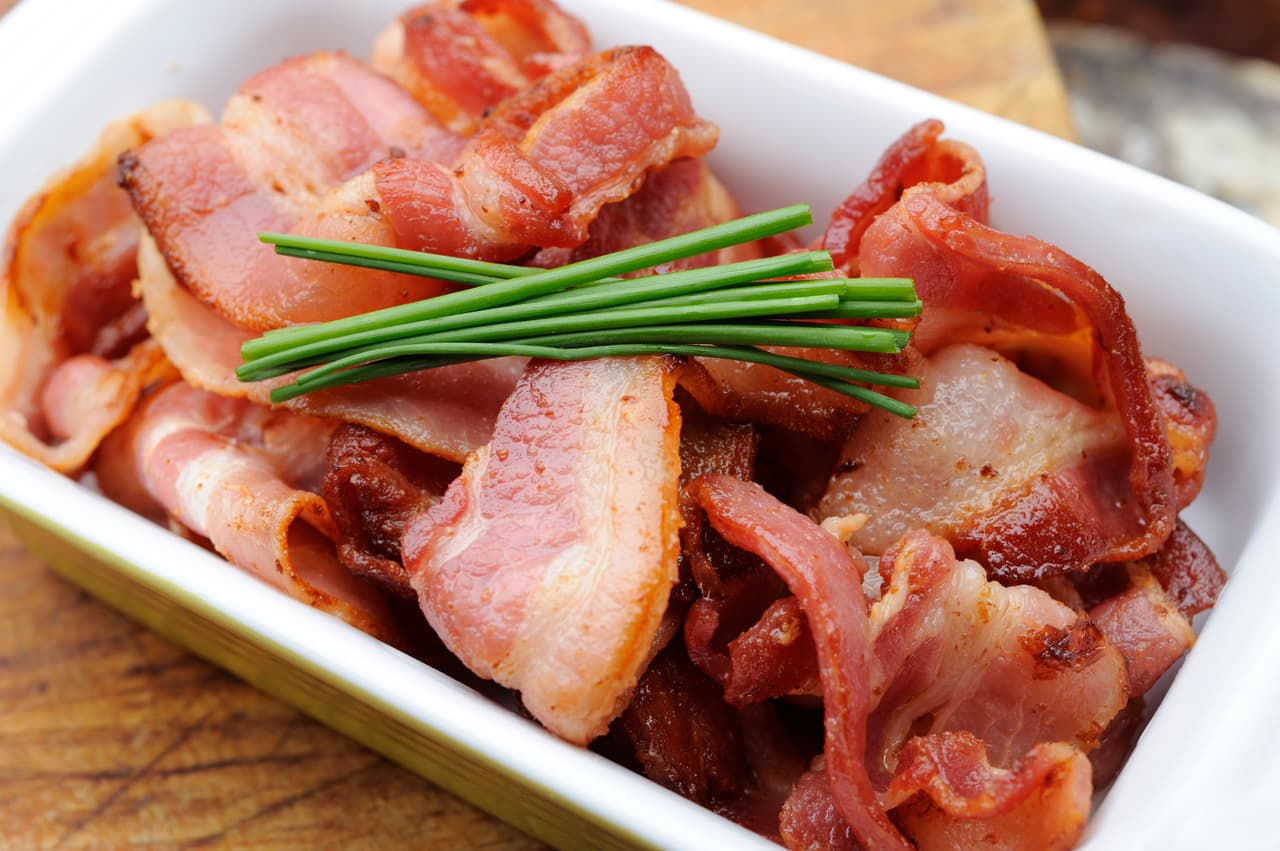 Cocina 4 oz (113 g) de tocino en una olla a fuego medio alto, hasta que esté crujiente (unos 6 minutos). Resérvalo, quita la grasa de la olla y agrégale 1 cucharada de mantequilla. Una vez derretida, añade 1 libra (453 g) de ‘baby kale’, 2/3 taza de jugo de naranja, sal y pimienta al gusto.