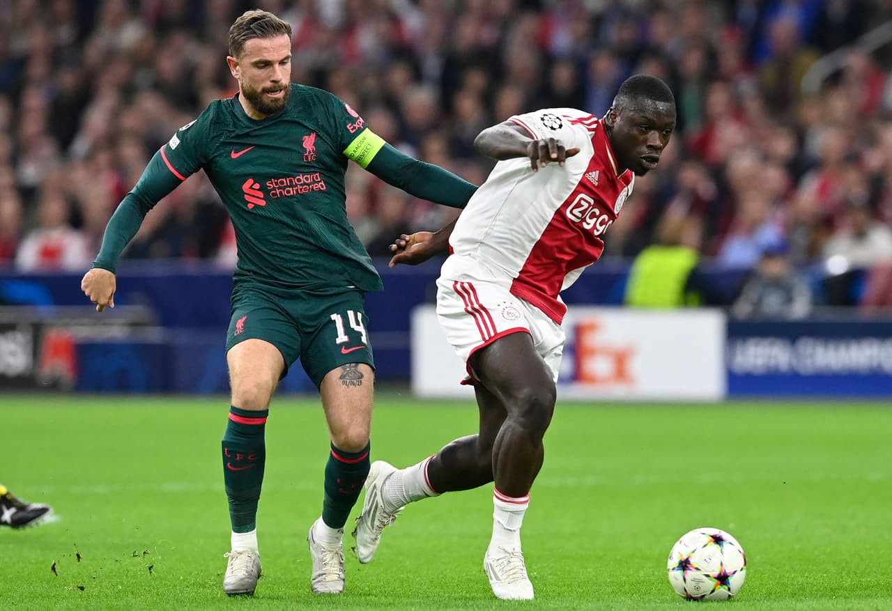 Liverpool's English midfielder Jordan Henderson (L) fights for the ball with Ajax's Dutch forward Brian Brobbey during the UEFA Champions League group A football match between Ajax Amsterdam and Liverpool at the Johan Cruijff ArenA in Amsterdam, on October 26, 2022. (Photo by JOHN THYS / AFP) (Photo by JOHN THYS/AFP via Getty Images)