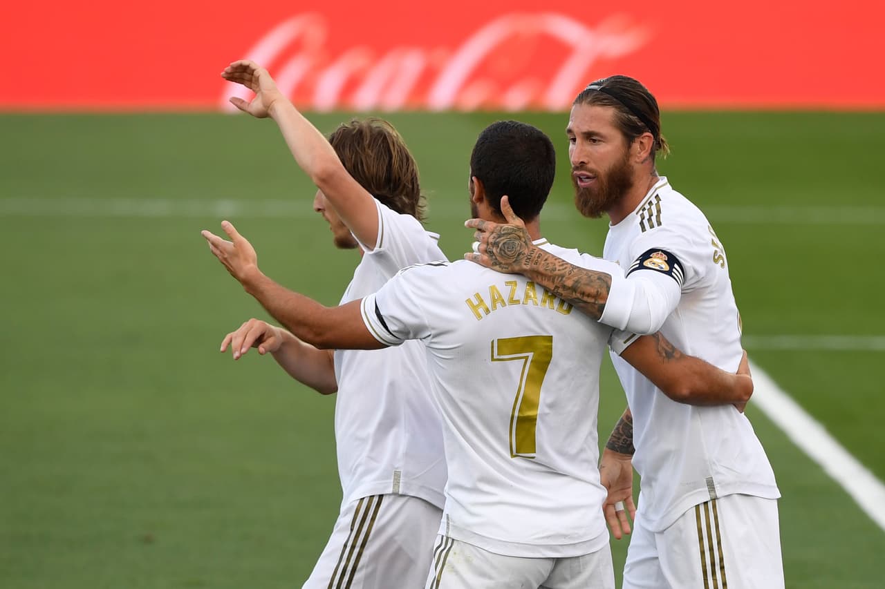 Real Madrid's Spanish defender Sergio Ramos (R) celebrates his goal with Real Madrid's Belgian forward Eden Hazard during the Spanish League football match between Real Madrid CF and SD Eibar at the Alfredo di Stefano stadium in Valdebebas, on the outskirts of Madrid, on June 14, 2020. (Photo by PIERRE-PHILIPPE MARCOU / AFP) (Photo by PIERRE-PHILIPPE MARCOU/AFP via Getty Images)