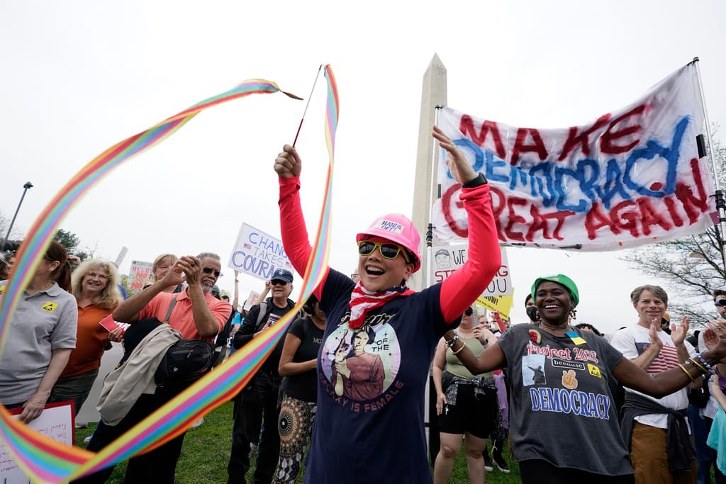 A demonstrator twirls a ribbon during a "Hands Off!" protest against President Donald Trump at the Washington Monument in Washington, Saturday, April 5, 2025. (AP Photo/Jose Luis Magana)
