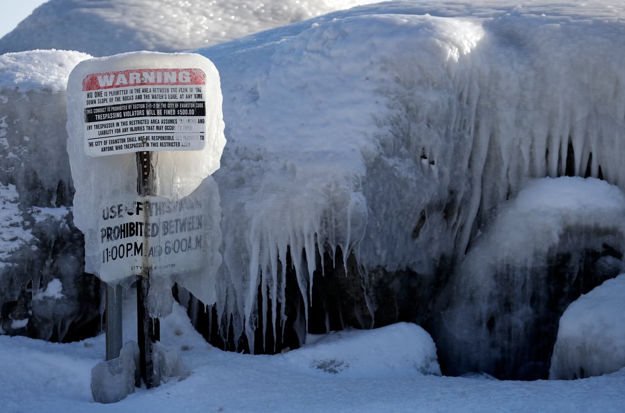 Una señal de advertencia cubierta de hielo en el parque Clark Square en Evanston, Illinois.
