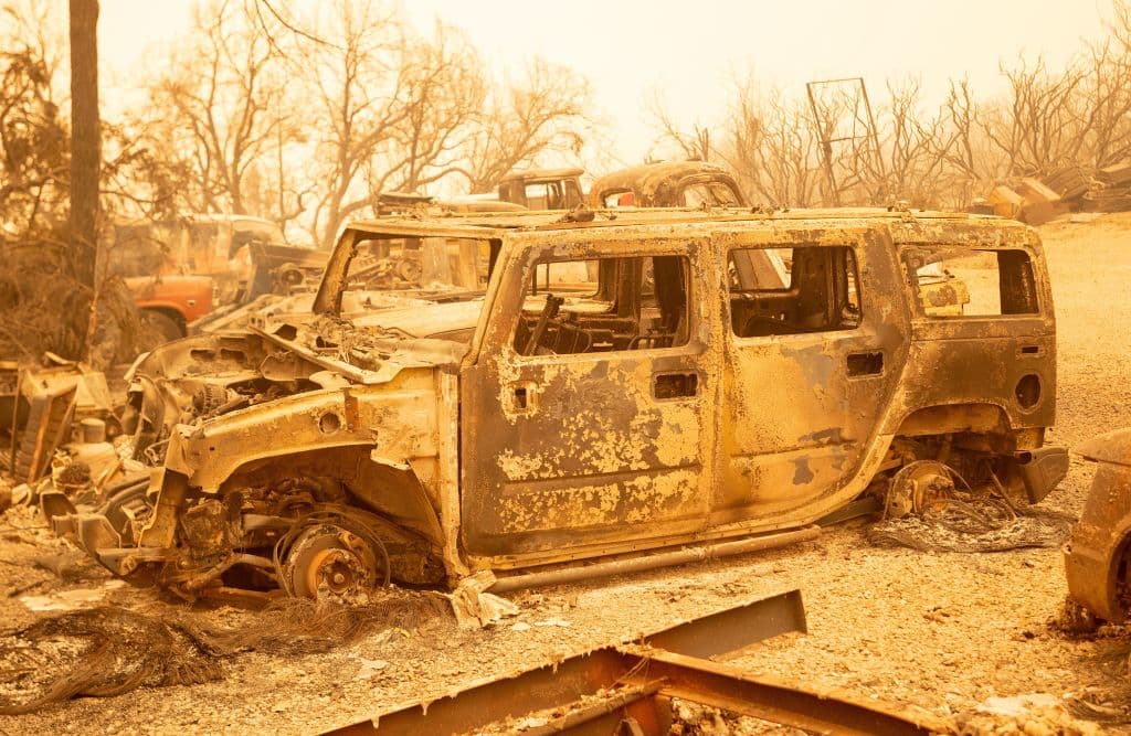 A burned Hummer vehicle smolders during the Creek fire in an unincorporated area of Fresno County, California on September 08, 2020. - Wildfires in California have torched a record more than two million acres, the state fire department said on September 7, as smoke hampered efforts to airlift dozens of people trapped by an uncontrolled blaze. (Photo by JOSH EDELSON / AFP) (Photo by JOSH EDELSON/AFP via Getty Images)