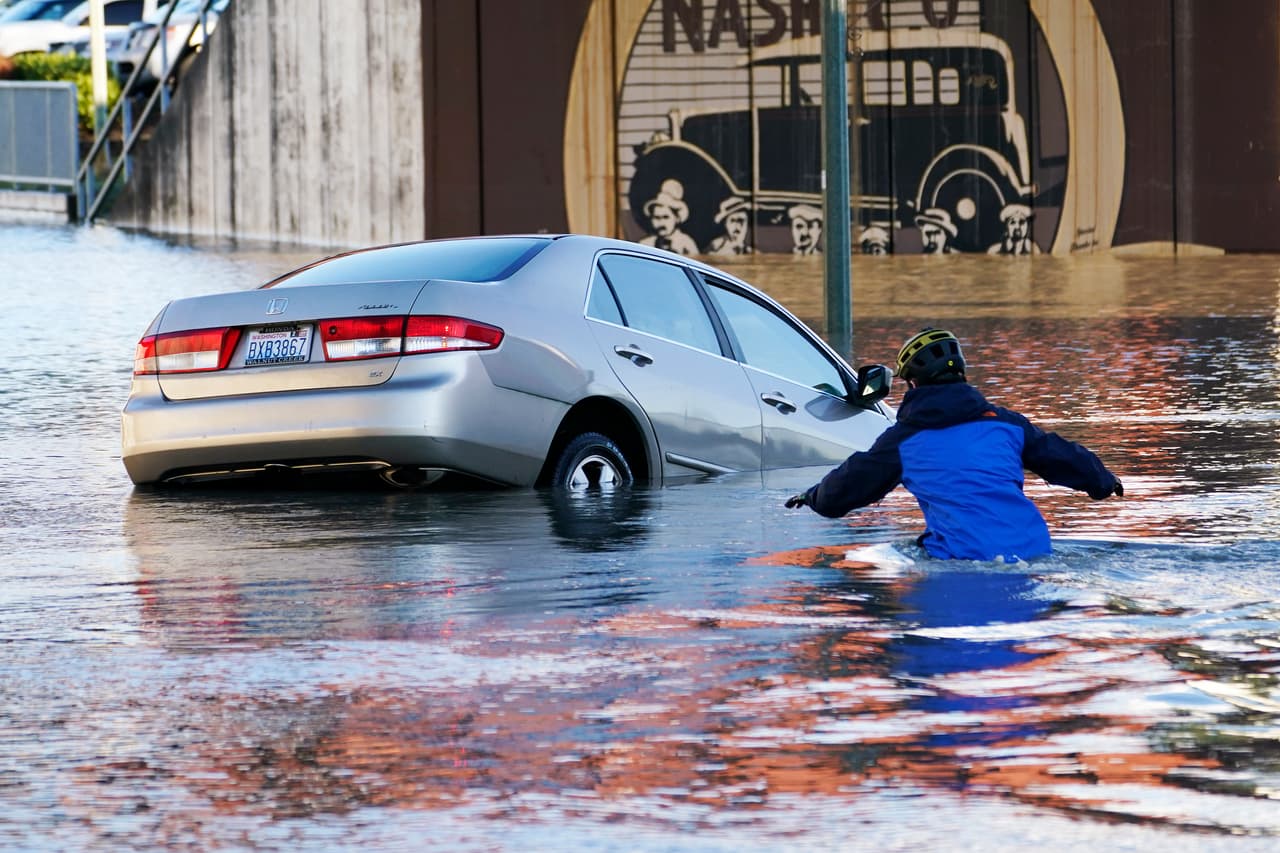Residentes de Ferndale, Washington, corren para rescatar al conductor de un auto que fue arrastrado por un río desbordado en la ciudad el 16 de noviembre.
<br>
<br>Poderosas lluvias causadas por un río atmosférico, una enorme columna de humedad que se extiende sobre la costa del pacífico norte, han causado estragos en la frontera entre Estados Unidos y Canadá.
<br>