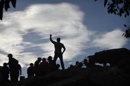 Rescue worker raises fist in appeal for silence, Mexico City, Sept 2017.