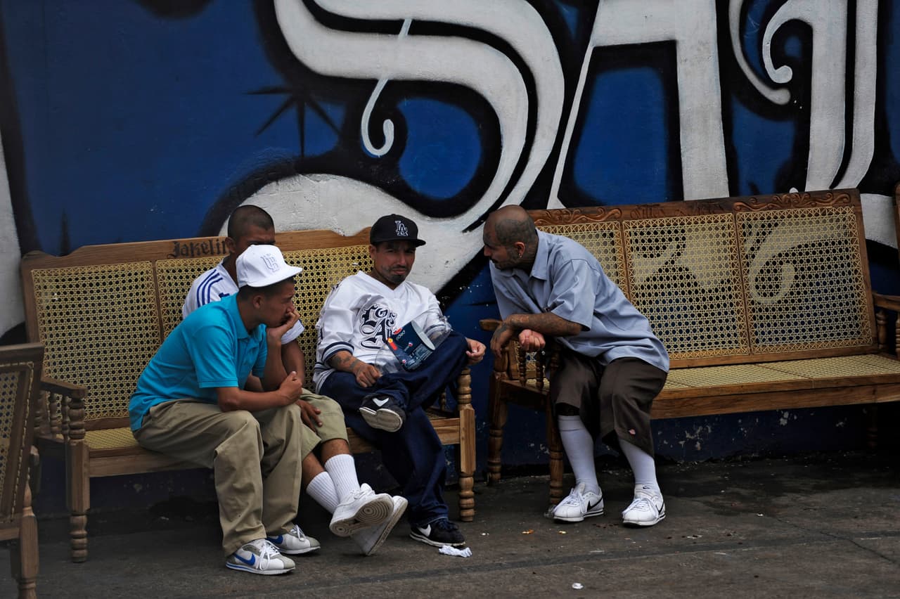 Mara Salvatrucha gang members remain at the prison of Ciudad Barrios, 160 km east of San Salvador, El Salvador on June 19, 2012. Inmates participated in a mass to celebrate 100 days after a truce was declared between gangs and the Salvadorean goverment. AFP PHOTO/ Jose CABEZAS (Photo credit should read Jose CABEZAS/AFP/GettyImages)