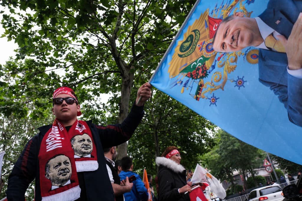 Un seguidor de Recep Tayyip Erdogan hondea una bandera del político y entona slogans frente a la sede del partido AKP, el partido de Erdogan, en Estambul, Turquía.
