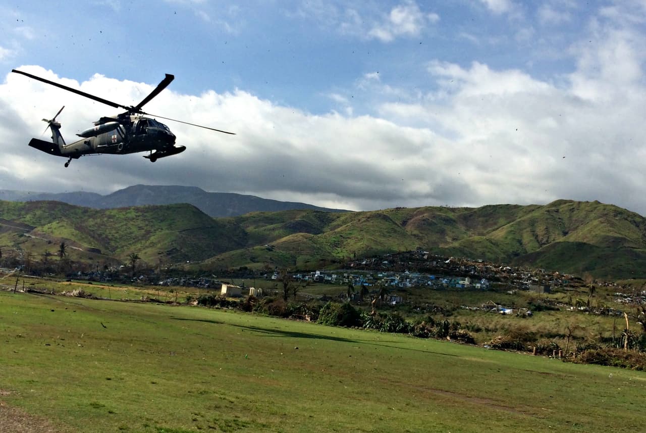 The post-hurricane relief effort did not reach Les Anglais until Saturday. This military helicopter carried two U.S. doctors to the town for a broef reconnaissance visit.