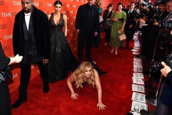 Amy hizo como que se tropezó entre la pareja y las decenas de fotógrafos.