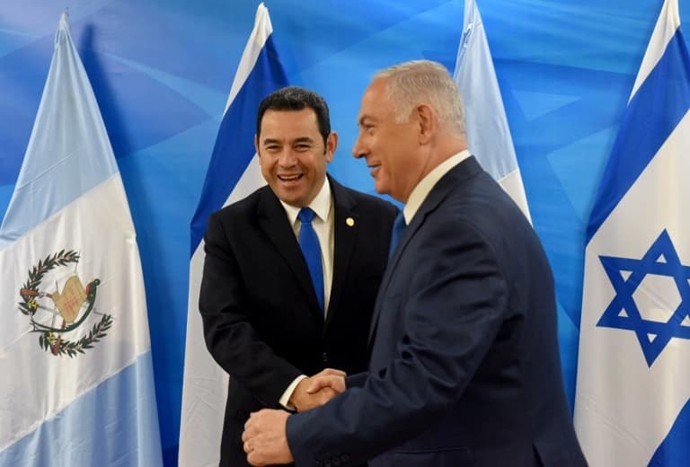 Guatemalan President Jimmy Morales (L) shakes hands with Israeli Prime Minister Benjamin Netanyahu as he is received at the Prime Minister's office in Jerusalem on May 16, 2018.