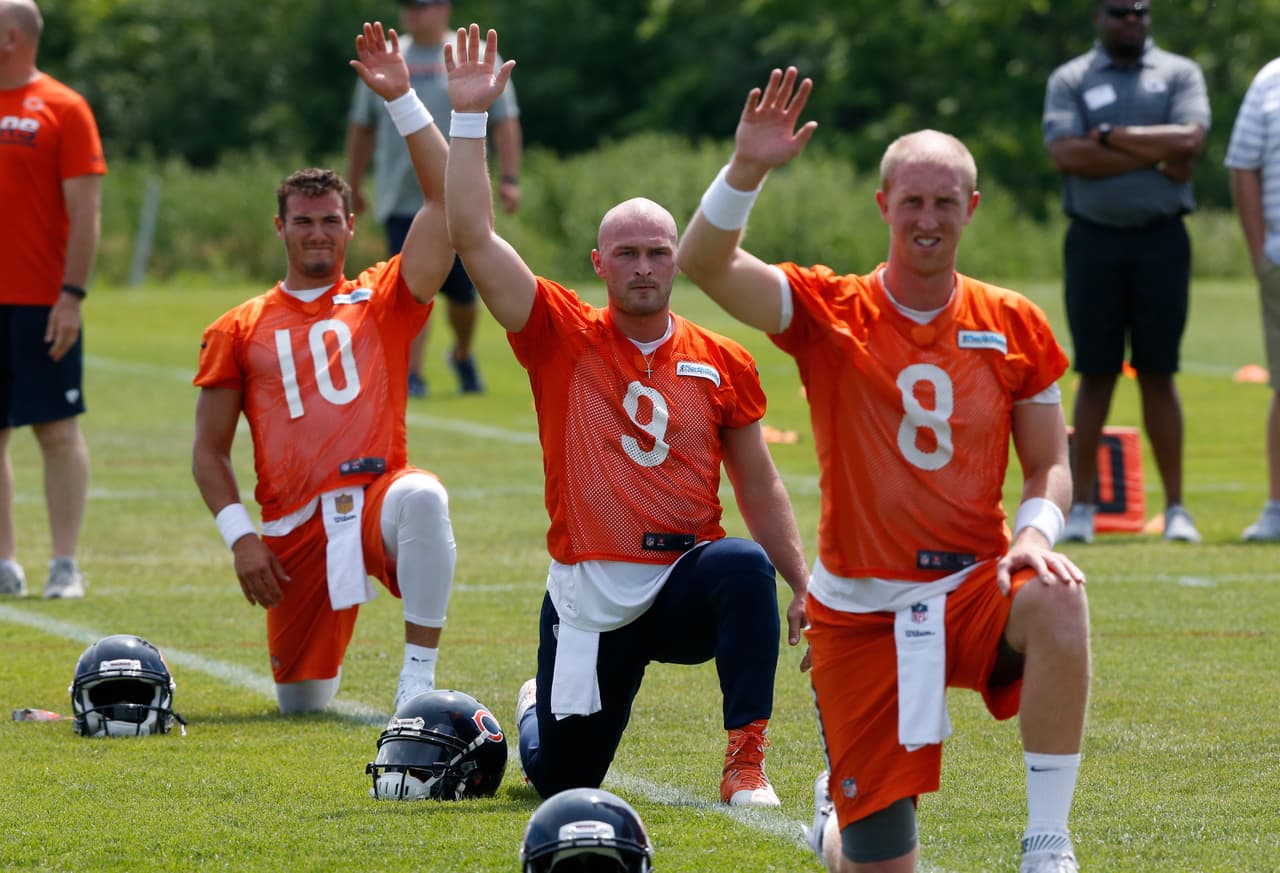 Chicago Bears quarterback Mitchell Trubisky (10), quarterback Connor Shaw (9), and quarterback Mike Glennon (8) stretch during the NFL football team's minicamp at Halas Hall, Wednesday, June 14, 2017, in Lake Forest, Ill. (AP Photo/Nam Y. Huh)