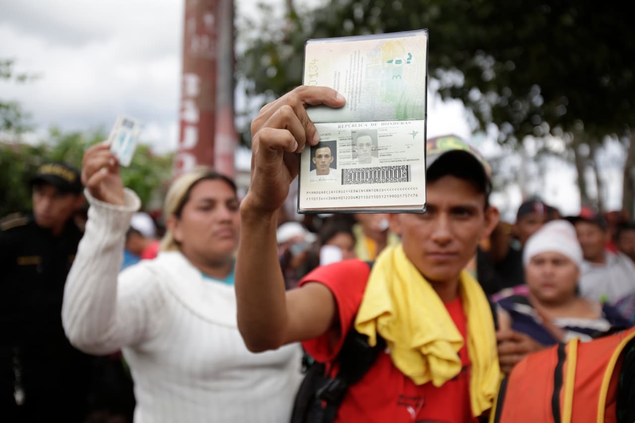 Edwin Antonio Garcia Cruz muestra su pasaporte hondureño a la policía guatemalteca que momentáneamente detuvo al grupo después de cruzar la frontera. Las razones con las que muchos migrantes justificarían una petición de asilo son la pobreza, la falta de empleos y la violencia, pero ninguna de estas causas garantizan su aprobación.